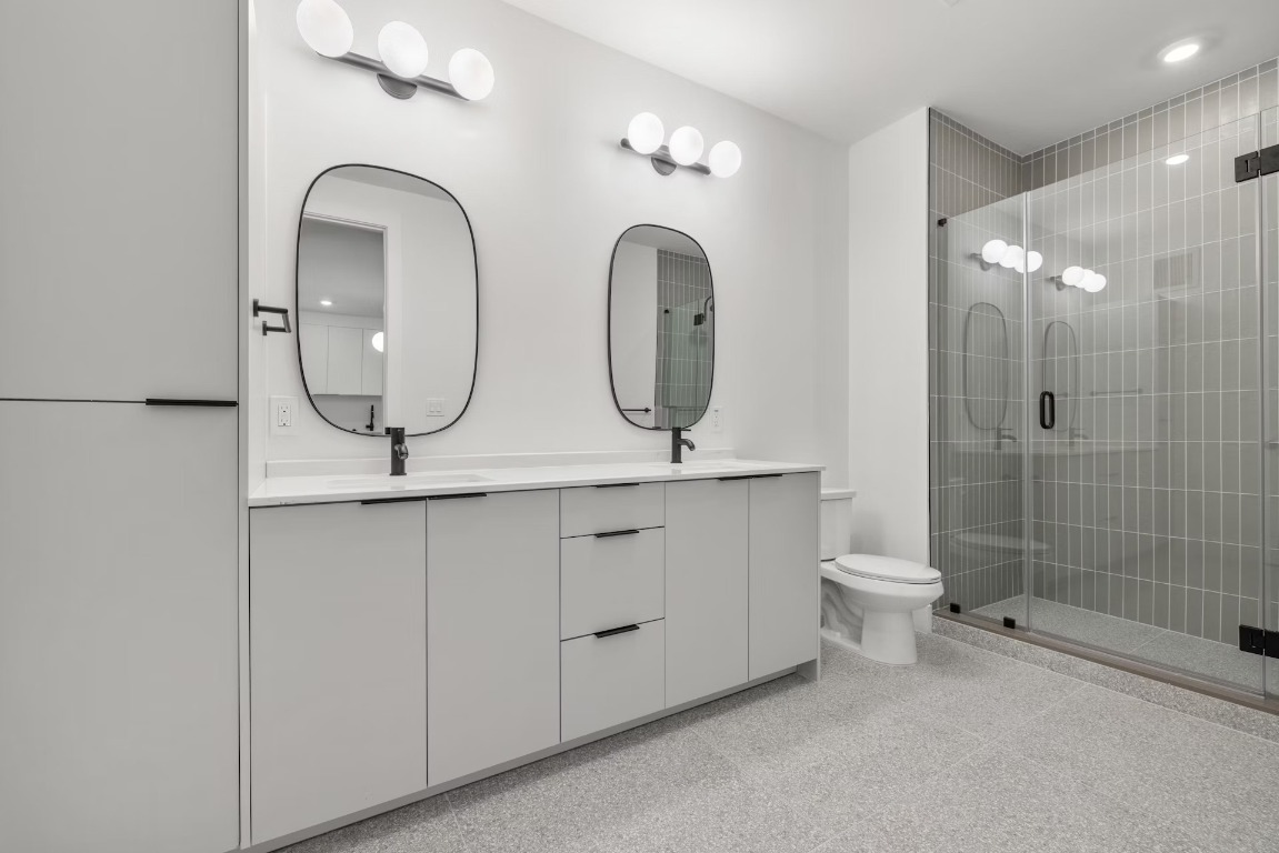 1701 Simond Avenue, Unit 208 Austin, TX 78723 - Photo 12 of 30 a bathroom with 2 sink a toilet and a mirror