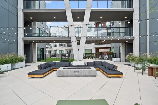a building outdoor space with patio furniture and potted plants