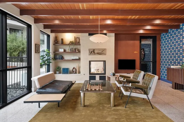 a living room with furniture a rug and a fireplace