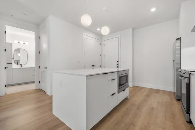 a bathroom with a sink a mirror and a shower