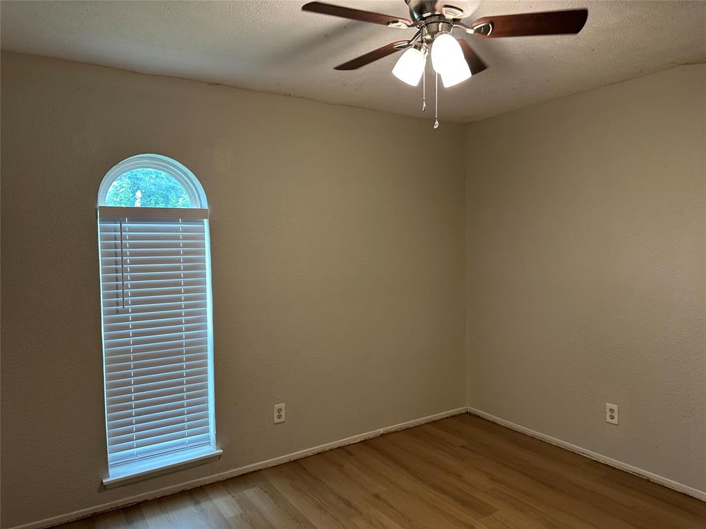 5908 Maple Lane Rowlett, TX 75089 - Photo 14 of 25 wooden floor in an empty room with a window