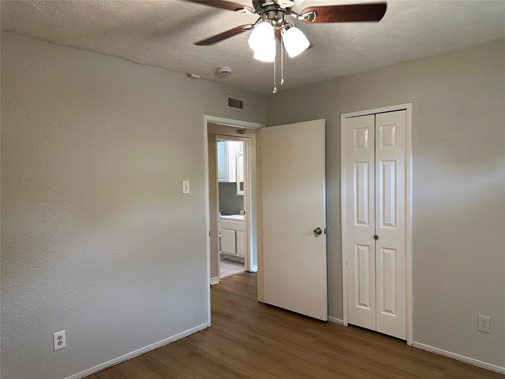 5908 Maple Lane Rowlett, TX 75089 - Photo 16 of 25 wooden floor in an empty room with a window