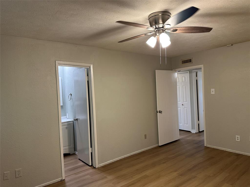5908 Maple Lane Rowlett, TX 75089 - Photo 19 of 25 an empty room with wooden floor and a ceiling fan