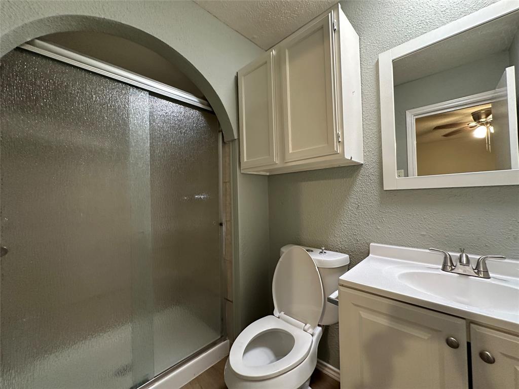 5908 Maple Lane Rowlett, TX 75089 - Photo 20 of 25 a bathroom with a toilet sink and mirror