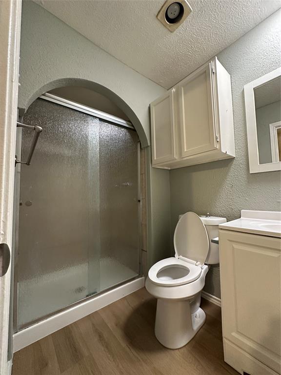 5908 Maple Lane Rowlett, TX 75089 - Photo 21 of 25 a bathroom with a toilet and a shower