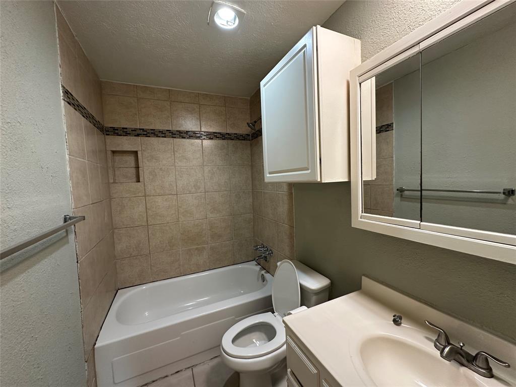 5908 Maple Lane Rowlett, TX 75089 - Photo 22 of 25 a bathroom with a sink a toilet and shower
