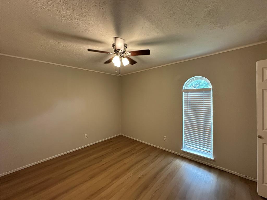 5908 Maple Lane Rowlett, TX 75089 - Photo 10 of 25 an empty room with wooden floor and windows