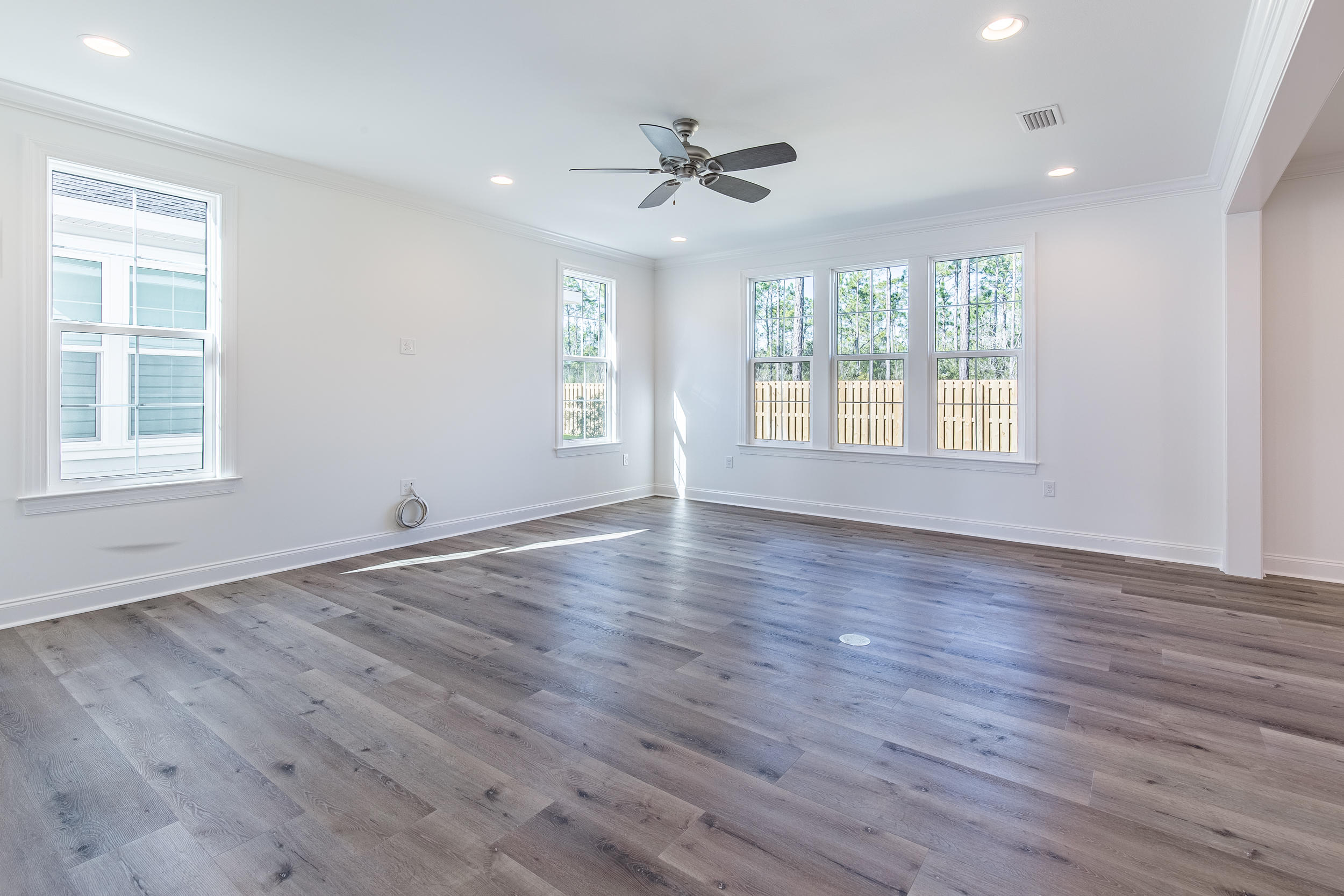 129 Windrow Way, Unit LOT 252 Watersound, FL 32461 - Photo 10 of 38 a view of an empty room with wooden floor and a window