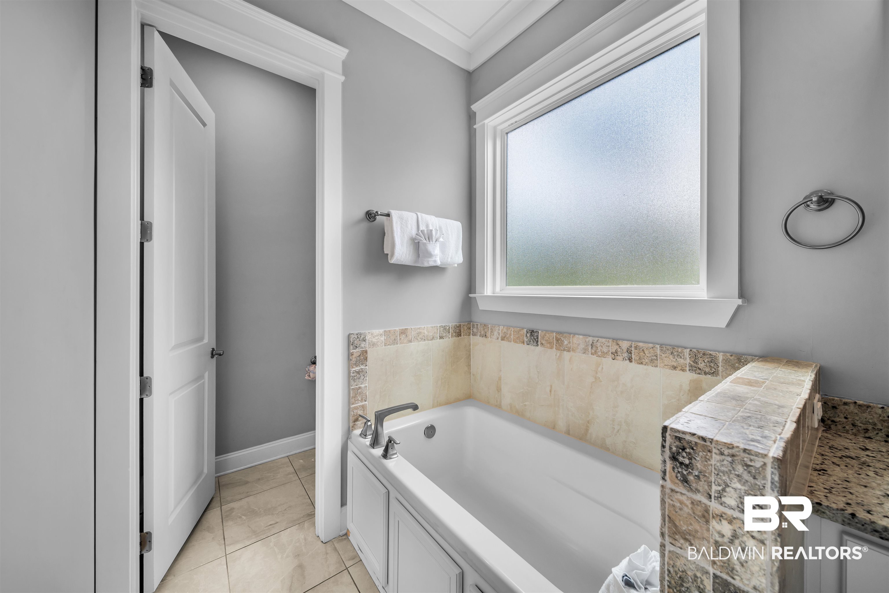 47 Parks Edge Orange Beach, AL 36561 - Photo 11 of 40 Bathroom featuring a garden tub, ornamental molding, and tile patterned floors