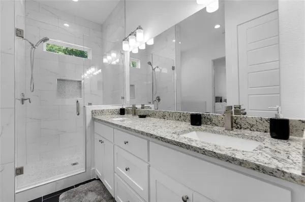 a bathroom with a bathtub sink and mirror