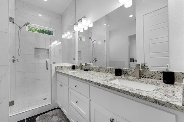 a bathroom with a bathtub sink and mirror