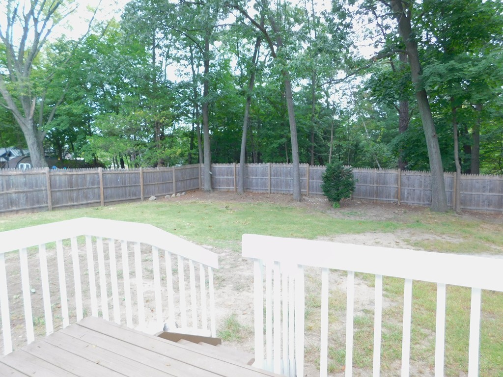 75 Anniversary Street Springfield, MA 01104 - Photo 12 of 12 a view of a backyard with a wooden fence