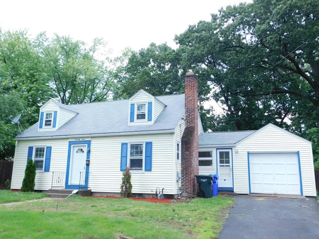 75 Anniversary Street Springfield, MA 01104 - Photo 2 of 12 a front view of a house with a yard and garage