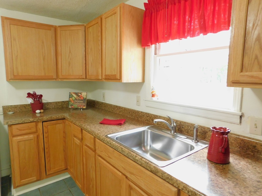 75 Anniversary Street Springfield, MA 01104 - Photo 3 of 12 a kitchen with a sink cabinets and a window