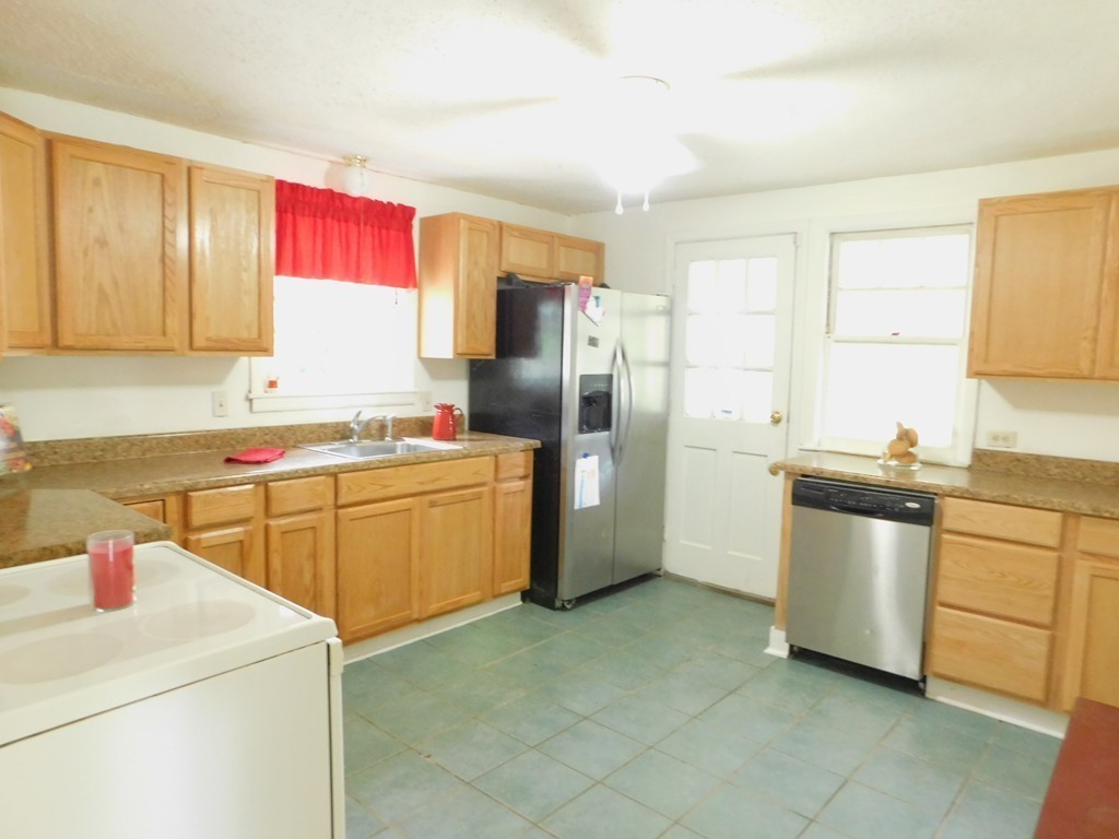 75 Anniversary Street Springfield, MA 01104 - Photo 4 of 12 a kitchen with a sink stove and refrigerator