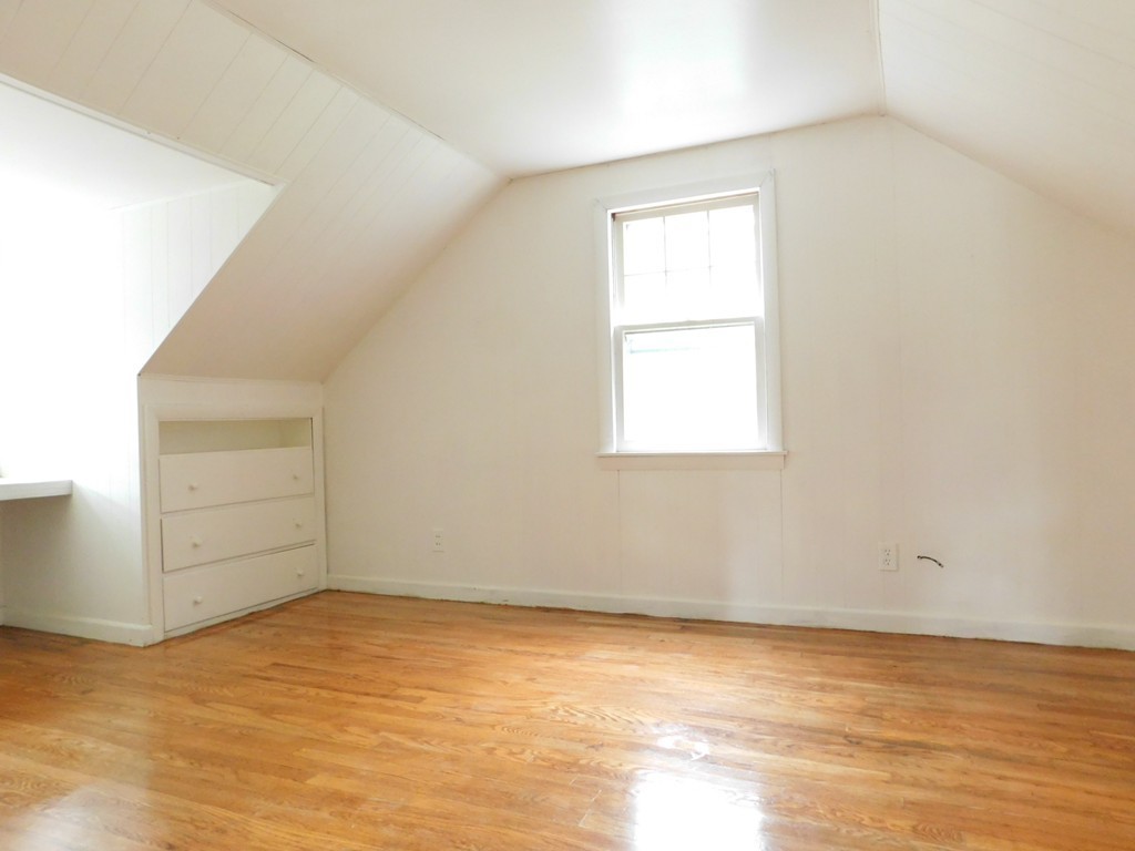 75 Anniversary Street Springfield, MA 01104 - Photo 8 of 12 an empty room with cabinet and windows