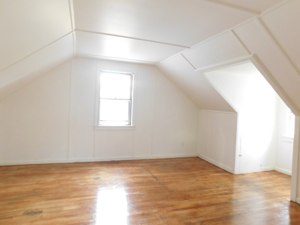 75 Anniversary Street Springfield, MA 01104 - Photo 9 of 12 a view of an empty room with wooden floor and a window