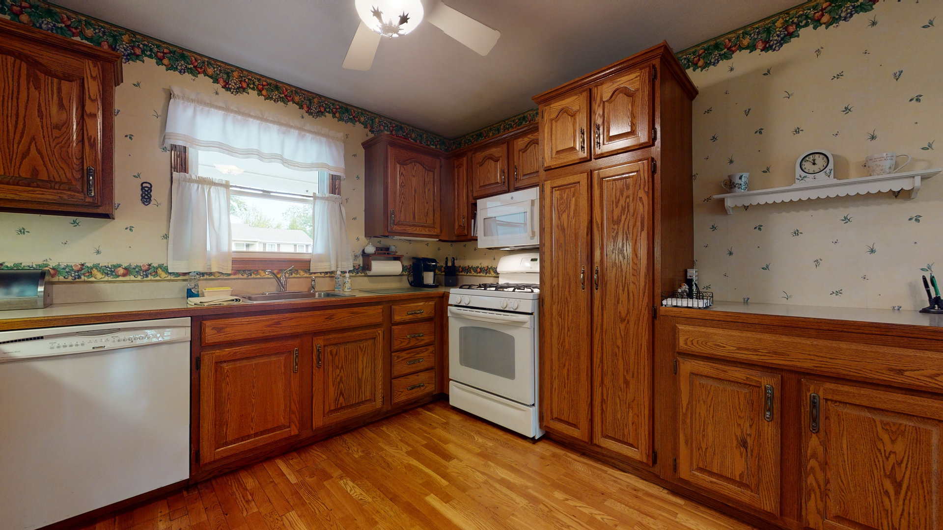 101 Stonegate Road Buffalo Grove, IL 60089 - Photo 3 of 18 a kitchen with stainless steel appliances granite countertop a refrigerator a sink dishwasher and wooden cabinets with wooden floor