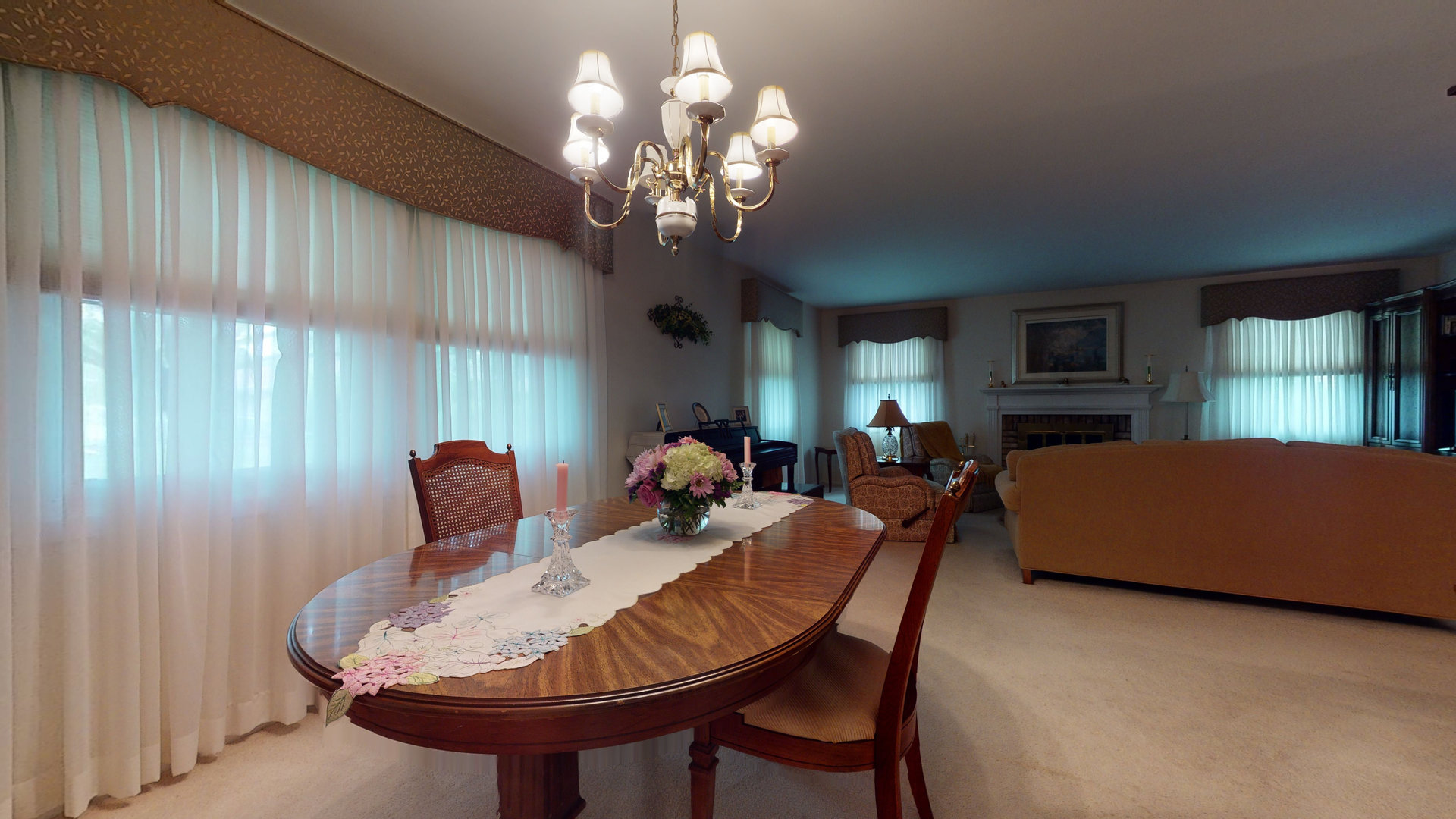 101 Stonegate Road Buffalo Grove, IL 60089 - Photo 7 of 18 a living room with furniture a chandelier and a dining room