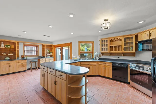 a kitchen with stainless steel appliances granite countertop a sink and cabinets