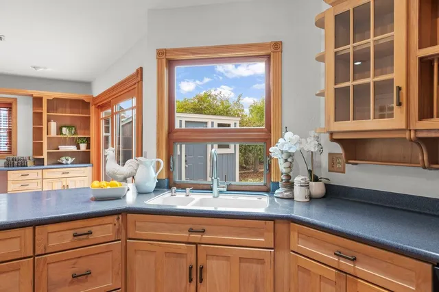 a kitchen with a sink and a large window
