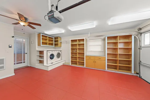 a view of an empty room with a fireplace and a window