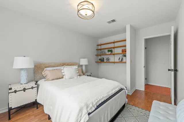 a bedroom with a bed and a lamp