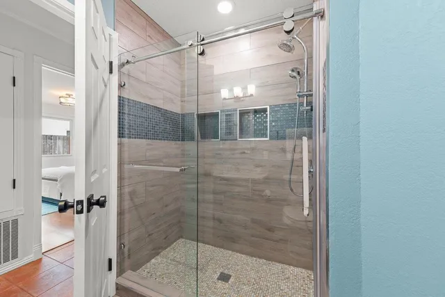 a bathroom with a glass shower door