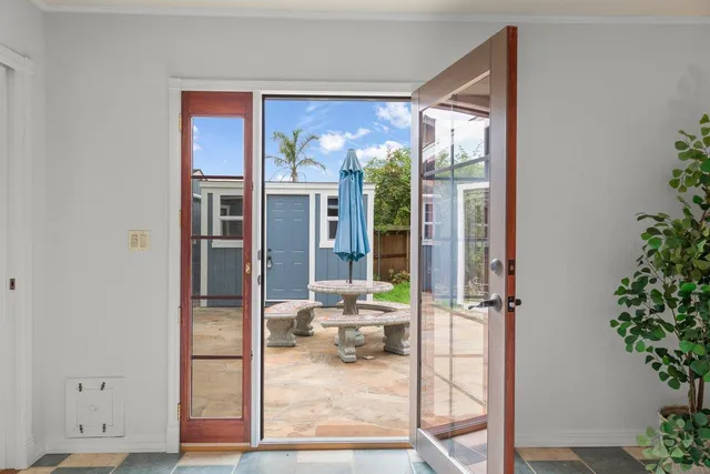 a view of a porch with a furniture and floor to ceiling window