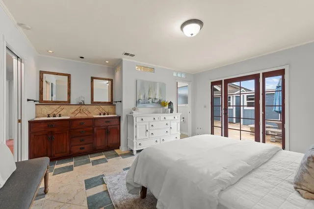 a bedroom with a large bed and a dresser