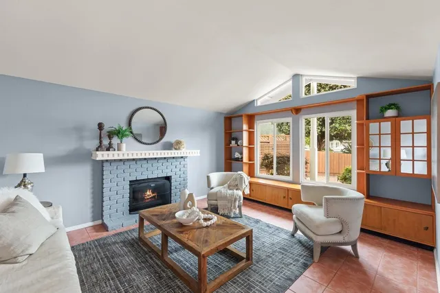 a living room with furniture and a fireplace
