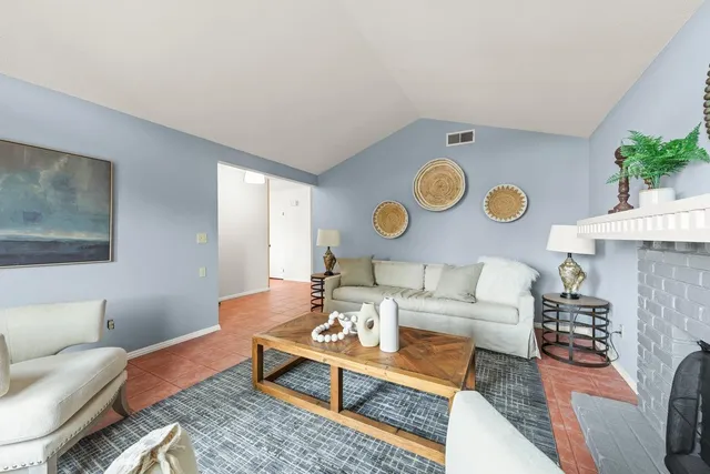 a living room with furniture and a clock