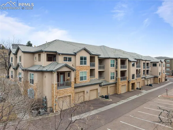 a front view of a residential apartment building with a yard