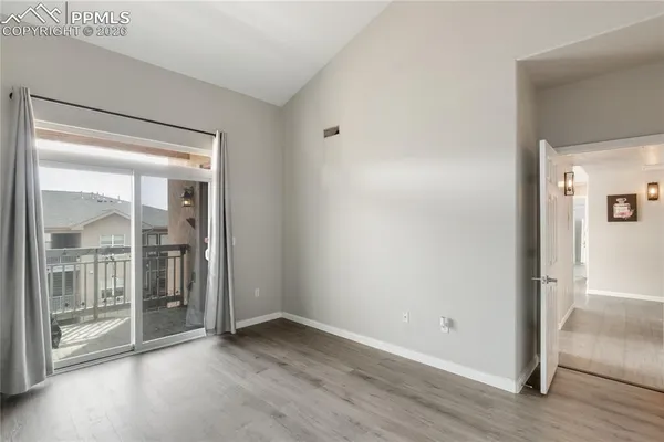 a view of an empty room and glass door