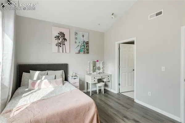 a bedroom with a bed and a table in it