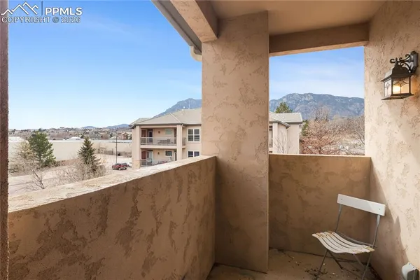 a view of a balcony with chair and table