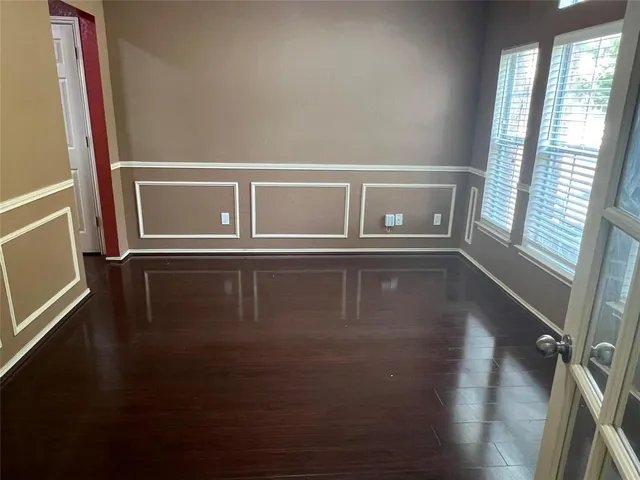 a view of wooden floor and windows in a room