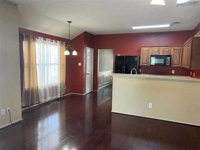a view of a livingroom with furniture wooden floor and window