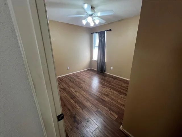wooden floor in an empty room with a mirror