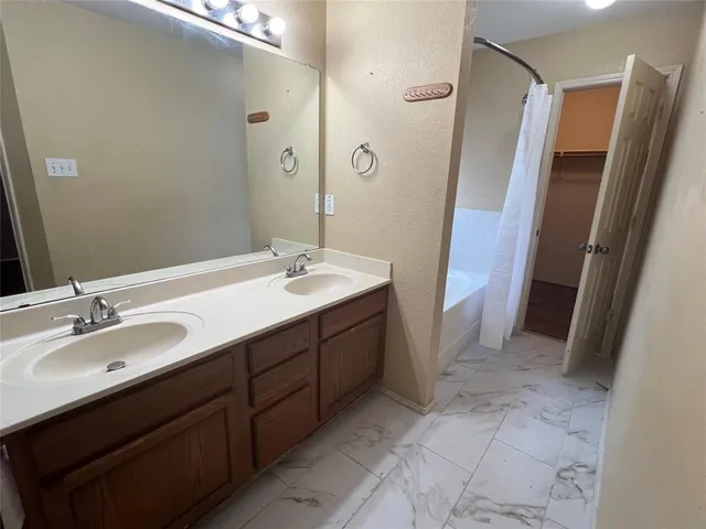 a bathroom with a double vanity sink and mirror