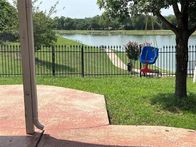swimming pool view with a lake view