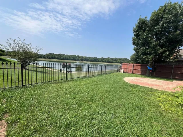 a view of a garden with a bench in the background