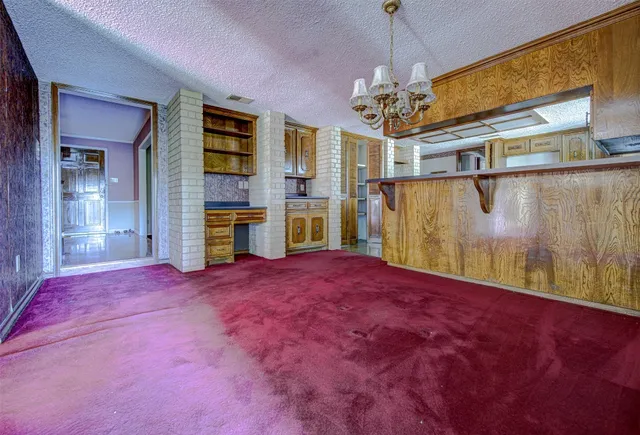 a big room with windows and fireplace