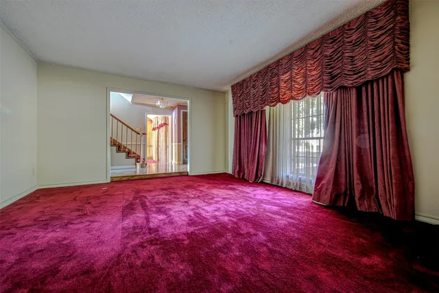 a view of a room with a balcony and window