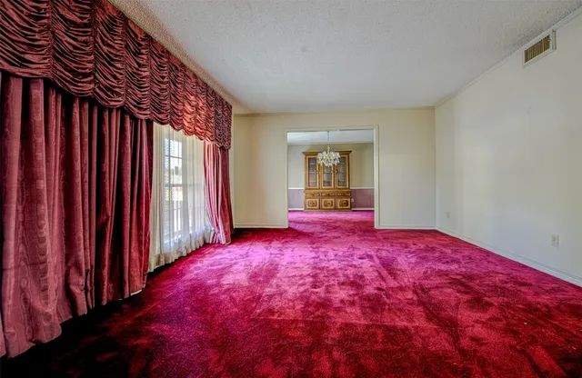 a view of a bedroom with a bed and wooden floor