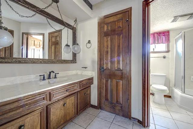a spacious bathroom with a sink and a mirror