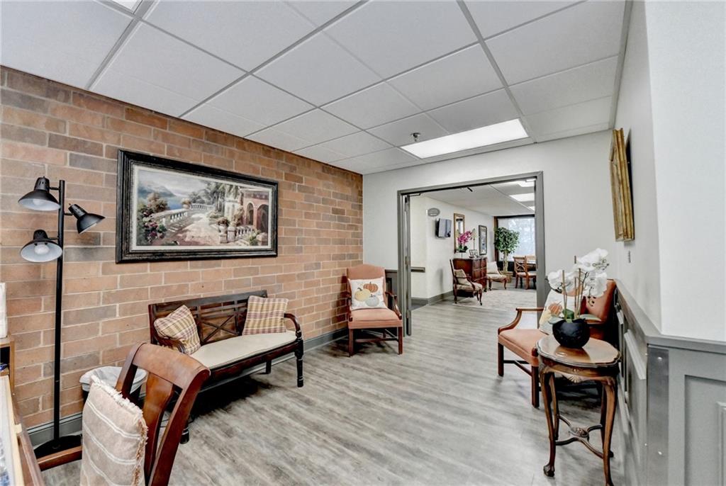 300 Johnson Ferry Road, Unit B409 Atlanta, GA 30328 - Photo 38 of 40 a living room with furniture and wooden floor