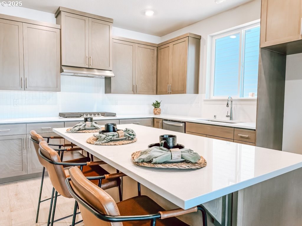 2630 South 4th Way Ridgefield, WA 98642 - Photo 15 of 32 a white kitchen with a table chairs and a refrigerator