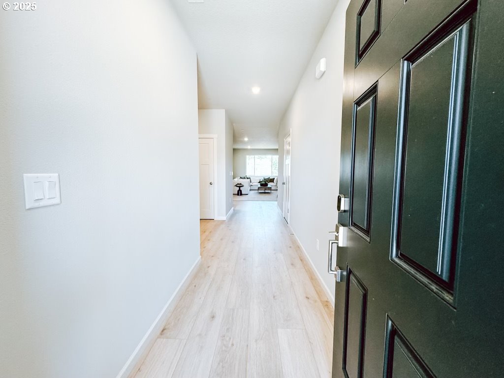 2630 South 4th Way Ridgefield, WA 98642 - Photo 3 of 32 a view of a hallway with wooden floor and a bathroom