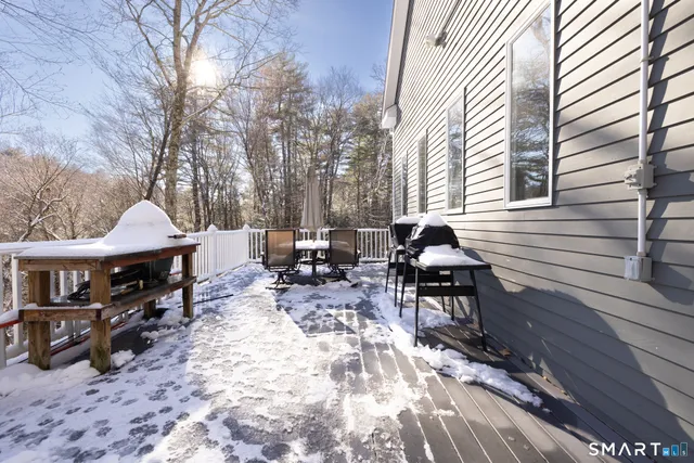 a backyard of a house with table and chairs